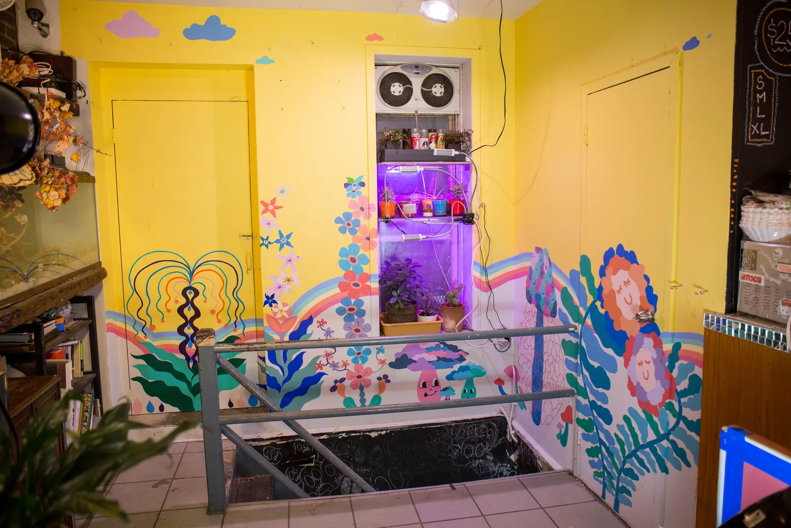 Yellow mural room with stairs down to the studio