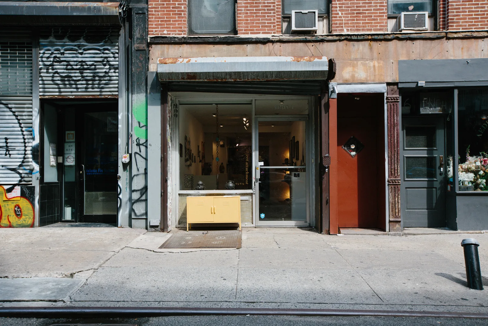 Sixteen B storefront in the morning, street empty