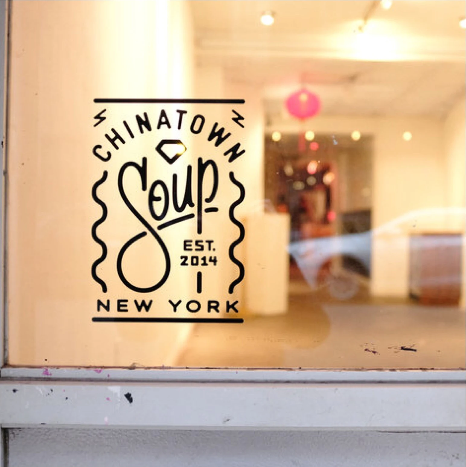 Chinatown Soup logo on the Orchard Street storefront window