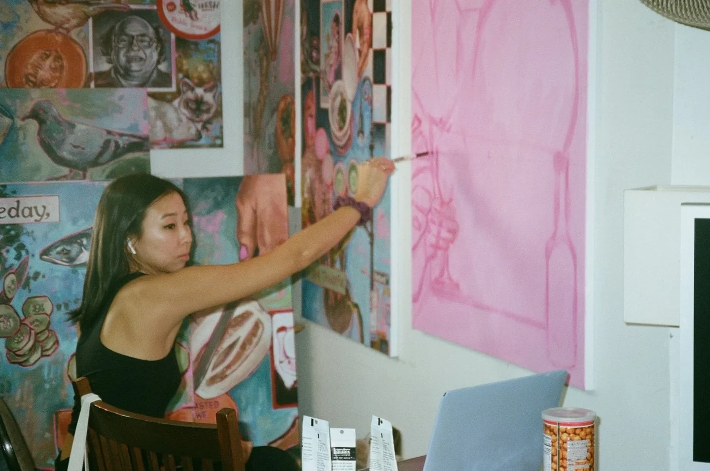 Clare Kim painting a pink canvas in her studio