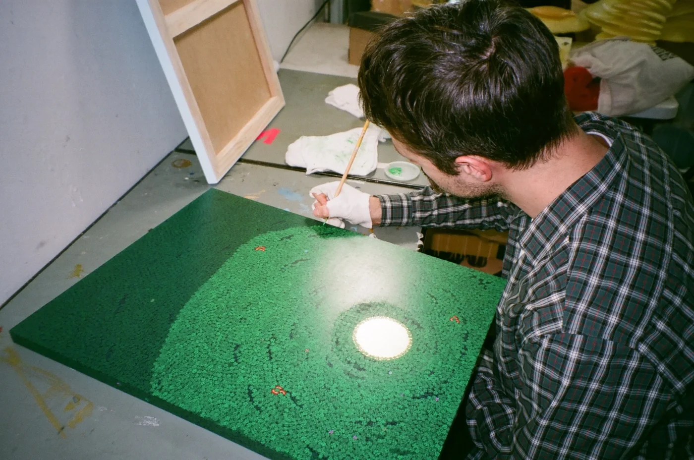 Vladan Sibinovic painting a green canvas on the studio floor