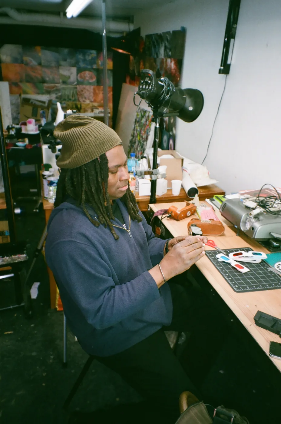 A resident assembling work at a studio bench