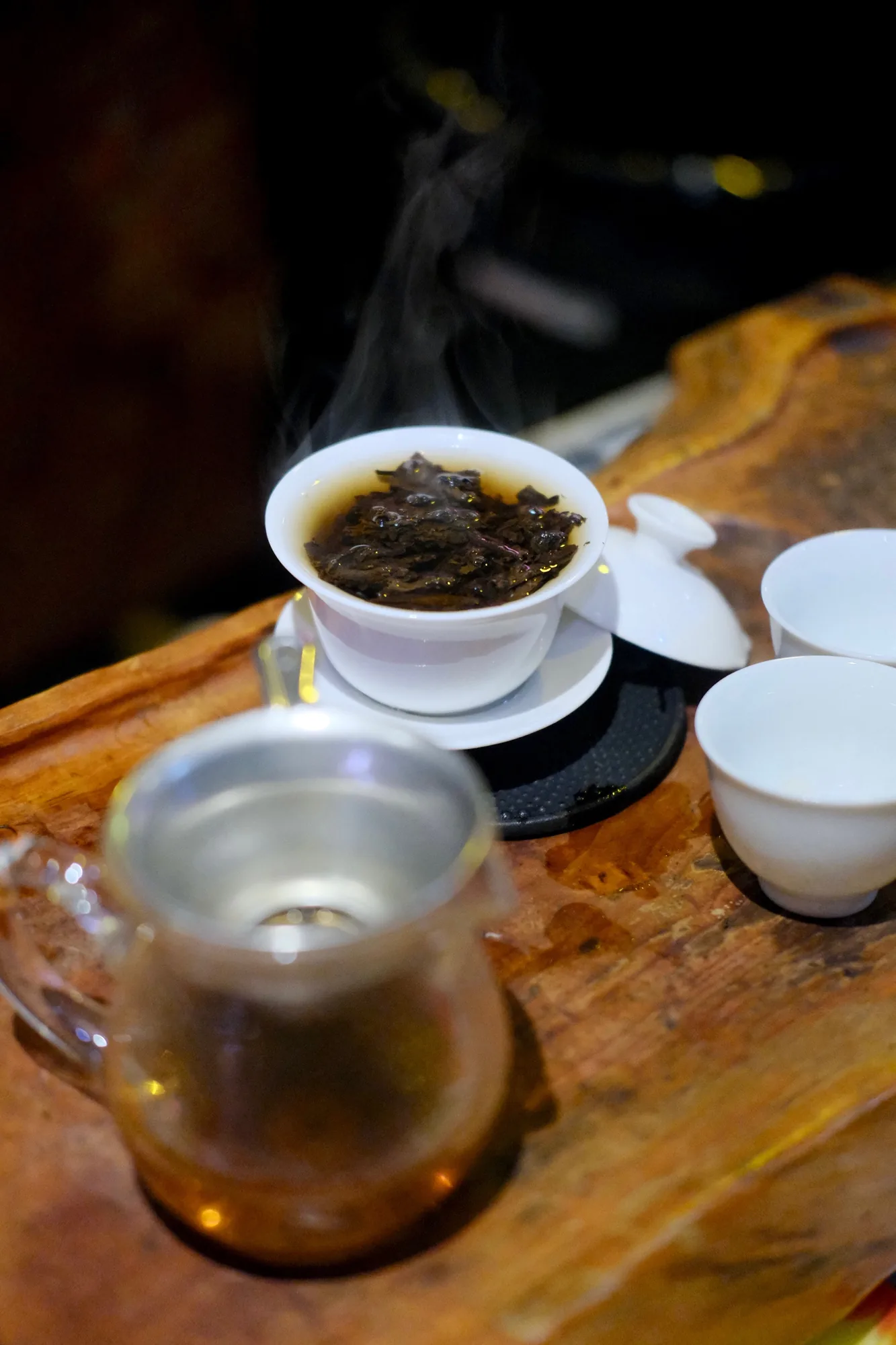Steam rising from a gaiwan of freshly brewed tea